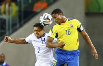 Emilio Izaguirre of Honduras (L) fights for the ball with Ecuador's Antonio Valencia during their 2014 World Cup Group E soccer match at the Baixada arena in Curitiba June 20, 2014. REUTERS/Stefano Rellandini (BRAZIL - Tags: SOCCER SPORT WORLD CUP)