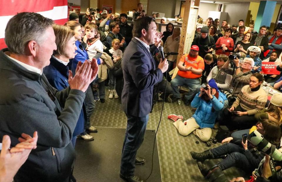 From left: Evangelical Leader Bob Vander Plaats, left, Iowa Governor Kim Reynolds, and Casey DeSantis, holding son Mason DeSantis, watch as Florida Gov. Ron DeSantis speaks during a rally on Saturday, Jan 13, 2023, at the Never Back Down super PAC headquarters in West Des Moines, IA.