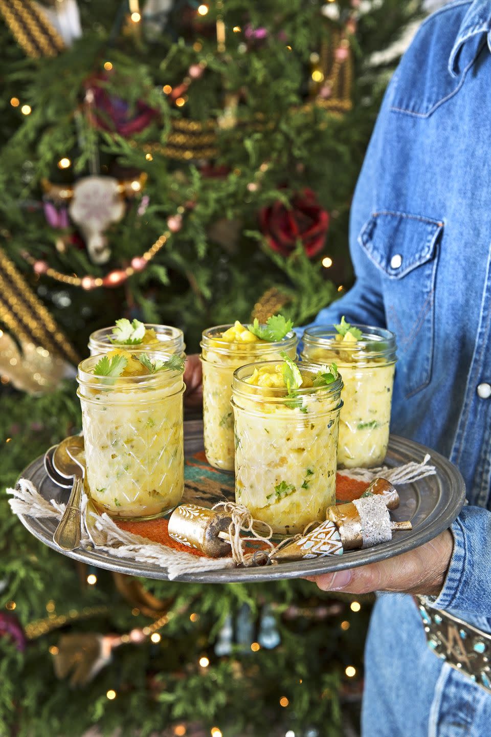 buttermilk and hatch chile grits in small quilted jars on a serving plate with spoons