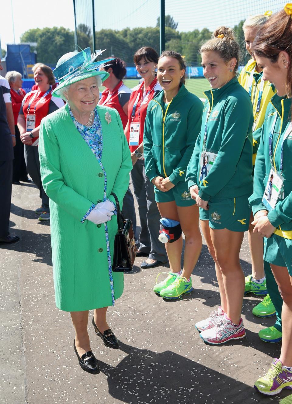 <p>No doubt the Queen is sharing a joke with this Australian Hockey Team about their matching outfits. [Photo: Getty] </p>