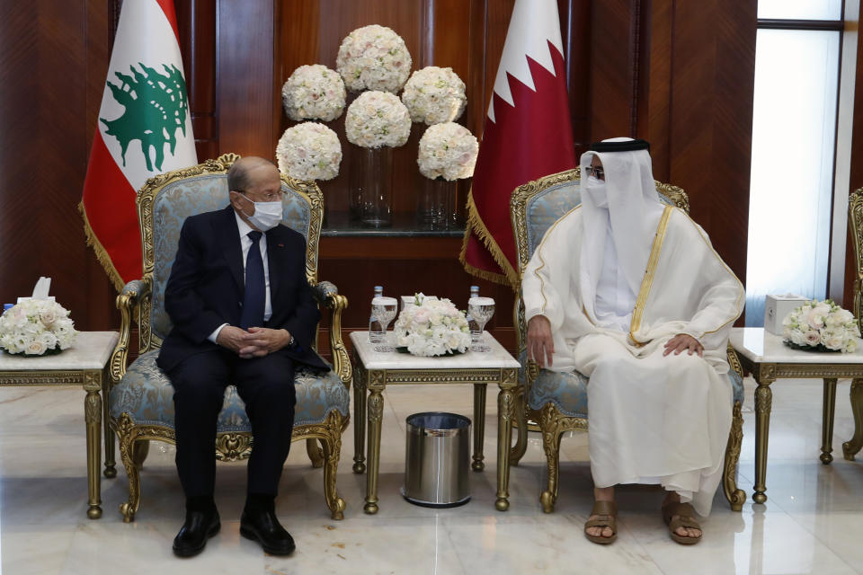 In this photo released by Lebanese government, Qatar's Emir Sheikh Tamim bin Hamad Al Thani, right, meets with Lebanese President Michel Aoun, in Doha, Qatar, Monday, Nov 29, 2021. Aoun arrived in Qatar Monday for the opening ceremony of an Arab soccer tournament amid - and for talks on an precedented diplomatic crisis between Beirut and oil-rich Gulf nations. (Dalati Nohra/Lebanese Official Government Photographer via AP)