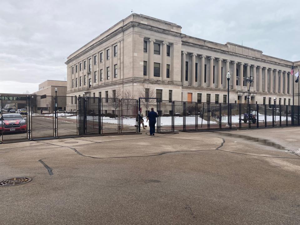The National Guard erected a fence outside the partially boarded up county courthouse and museum