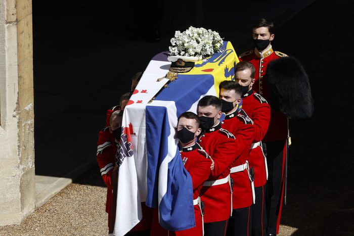 WINDSOR, ENGLAND - APRIL 17: The bearer Party found by The Queen’s Company, 1st Battalion Grenadier Guards carry the coffin of HRH Prince Philip, Duke of Edinburgh to the purpose built Land Rover Hearse during the funeral of Prince Philip, Duke of Edinburgh at Windsor Castle on April 17, 2021 in Windsor, England. Prince Philip of Greece and Denmark was born 10 June 1921, in Greece. He served in the British Royal Navy and fought in WWII. He married the then Princess Elizabeth on 20 November 1947 and was created Duke of Edinburgh, Earl of Merioneth, and Baron Greenwich by King VI. He served as Prince Consort to Queen Elizabeth II until his death on April 9 2021, months short of his 100th birthday. His funeral takes place today at Windsor Castle with only 30 guests invited due to Coronavirus pandemic restrictions. (Photo by Adrian Dennis/WPA Pool/Getty Images)