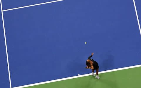 Serena Williams of the US serves to Naomi Osaka of Japan during their 2018 US Open women's singles final match on September 8, 2018 in New York - Credit: AFP