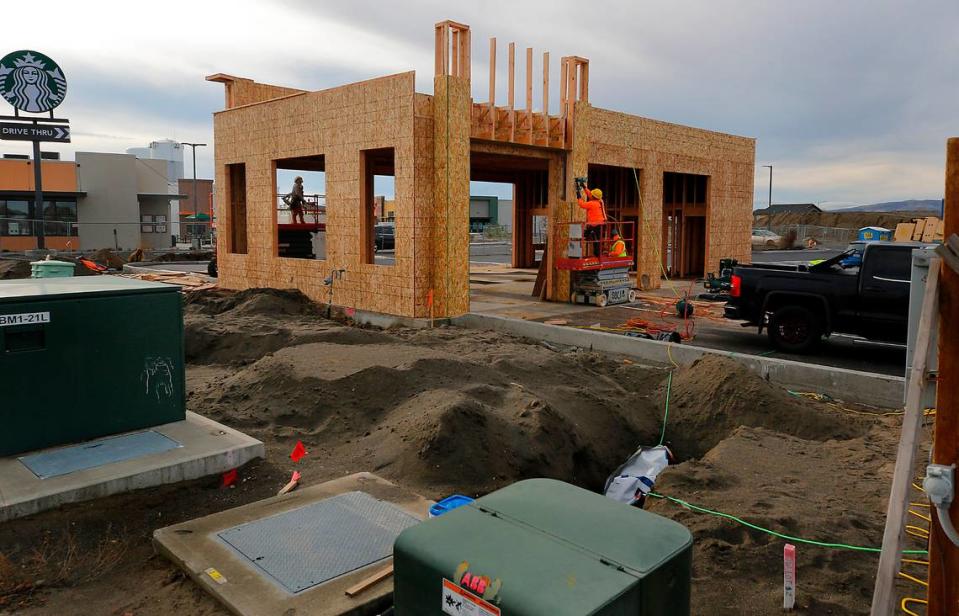 Construction crews work on the new three bay Take 5 Oil Change building on the corner of Road 68 and Three Rivers Drive in west Pasco.