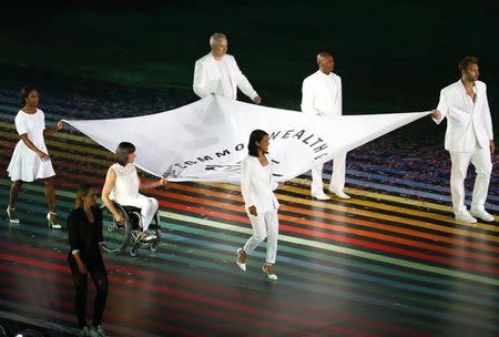 The Commonwealth flag is carried into the stadium during the opening of the 2014 Commonwealth Games at Celtic Park in Glasgow, Scotland, July 23, 2014. REUTERS/Andrew Winning