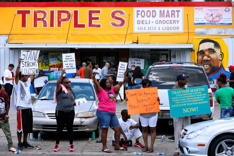 Protesters demonstrate outside the Triple S Food Mart where Alton Sterling was shot dead.