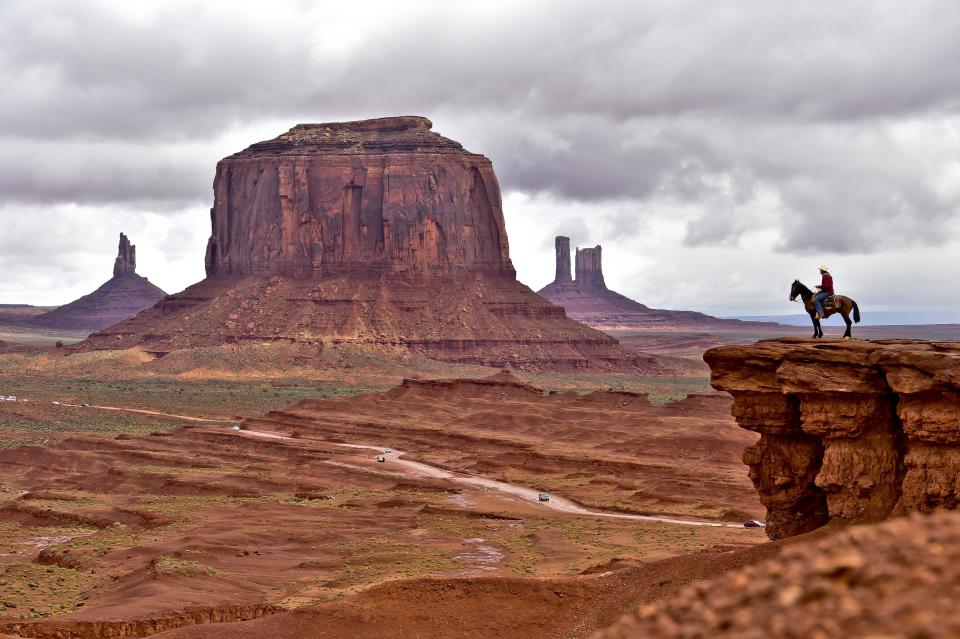 A Navajo man on a horse poses for tourists in Monument Valley Navajo Tribal Park in Utah on May 16, 2015.