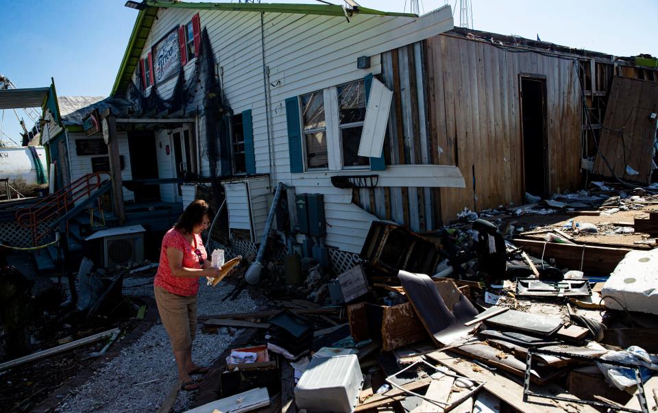 Chris Gala, a part owner of Trico shrimp company, visits the business at Fort Myers Beach shrimp docks on Dec, 6, 2022. Her business has been at a standstill since it was decimated by Hurricane Ian. She is hopeful for the future of the business.