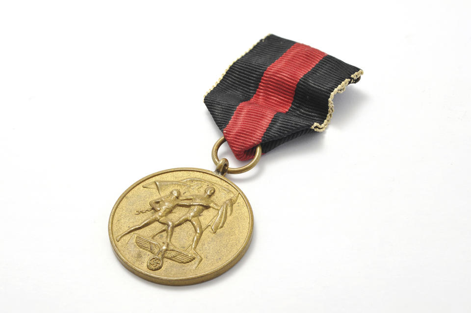 This Feb. 25, 2019 photo shows a medal. Several personal possessions of Oskar Schindler, the German industrialist credited with saving the lives of more than 1,000 Jews during World War II, are up for auction. Schindler's Longines wristwatch, a compass he and his wife reportedly used in 1945 as they fled advancing Russian troops, two Parker fountain pens in a case, and several other items are being sold by RR Auction of Boston. The belongings are being sold as a package and are expected to fetch about $25,000 in the auction that ends March 6. (Howard Fohlin/RR Auction via AP)