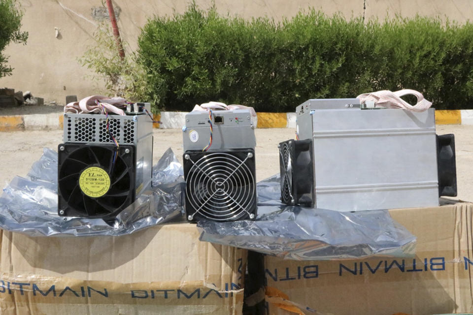 This undated photo provided by the Police News Agency, shows boxes of machinery used in Bitcoin "mining" operations that were confiscated by police in Nazarabad, Iran. Squeezed by sanctions and fueled by subsidized electricity, Iranians and others lured to the country increasingly are turning to Bitcoin and other digital cryptocurrencies. Some mine for the currency. That involves harnessing the power of their computers to verify and secure other users’ transactions around the world so that the same bitcoin isn’t spent twice. They are given new bitcoins as rewards. (News.police.ir via AP)