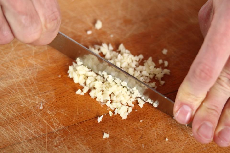 Mince garlic by hand.