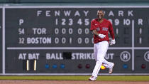 Boston Red Sox's Rafael Devers looks toward teammates while celebrating after his winning RBI-single in the bottom of the ninth inning of a baseball game against the Toronto Blue Jays at Fenway Park, Monday, June 14, 2021, in Boston. (AP Photo/Charles Krupa)