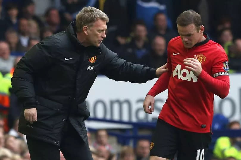 Manager David Moyes speaks to Wayne Rooney during the match between Everton and Manchester United