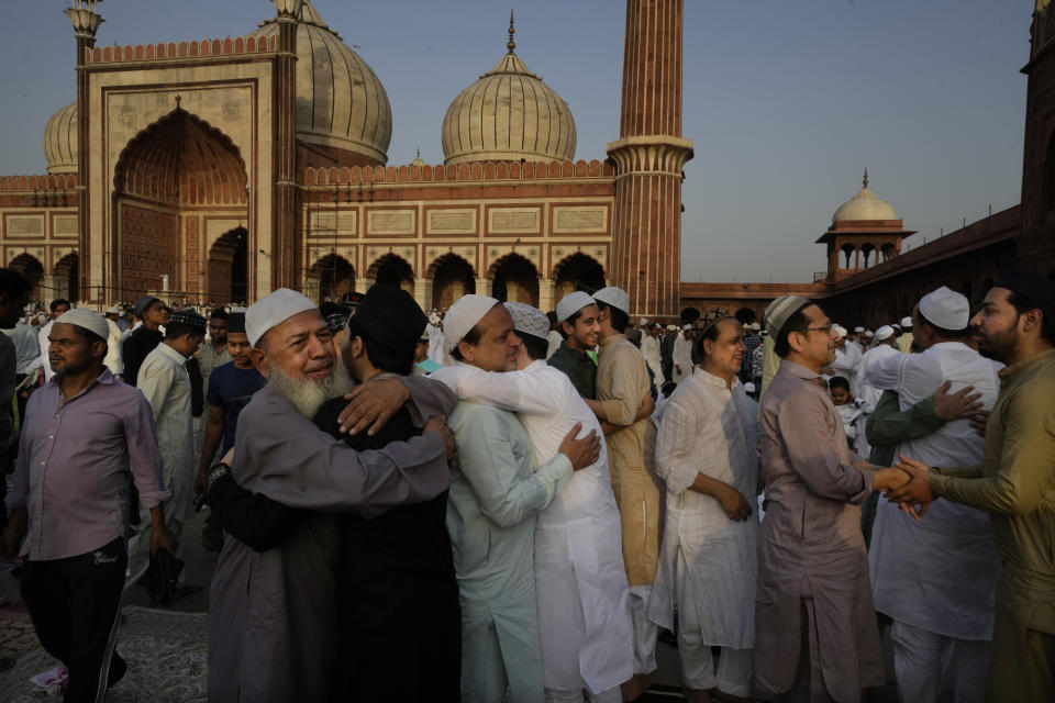 Devout Muslims greet and hug each other after offering Eid al-Adha prayers at the Jama Masjid, in New Delhi, India, Monday, June 17, 2024. Muslims around the world celebrate Eid al-Adha by sacrificing animals to commemorate the prophet Ibrahim's faith in being willing to sacrifice his son. (AP Photo/Manish Swarup)