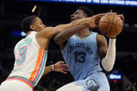 Memphis Grizzlies forward Jaren Jackson Jr. (13) drives to the basket against San Antonio Spurs forward Keldon Johnson (3) during the second half of an NBA basketball game, Wednesday, Jan. 26, 2022, in San Antonio. (AP Photo/Eric Gay)