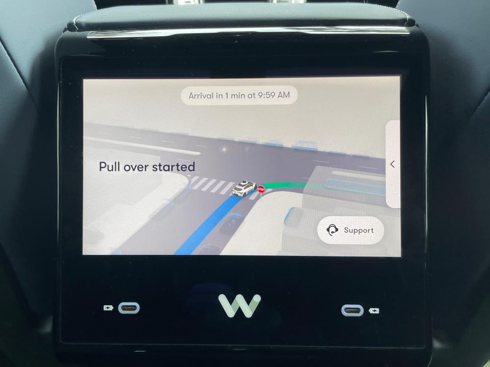 Image of Waymo's touchscreen console indicates to the rider that the vehicle is attempting to pull over.