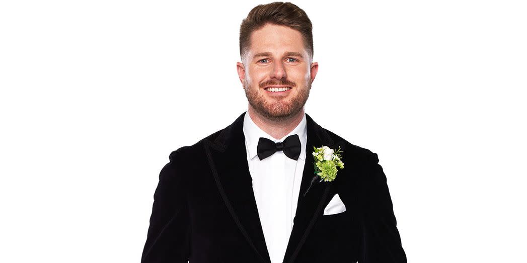 married at first sight australia bryce ruthven in a suit against a white background