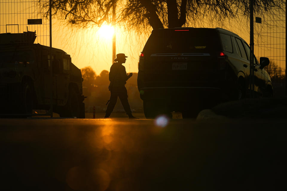 FILE - A guardsman checks a vehicle at the gate for Shelby Park, which troops from the Texas National Guard seized and began turning away federal immigration authorities, Thursday, Feb. 1, 2024, in Eagle Pass, Texas. Texas will build an operations base for up to 1,800 National Guard members in Eagle Pass, expanding the presence of soldiers in the border city where the state has clashed with the Biden administration over immigration enforcement, Republican Gov. Greg Abbott announced Friday, Feb. 16, 2024. (AP Photo/Eric Gay, File)