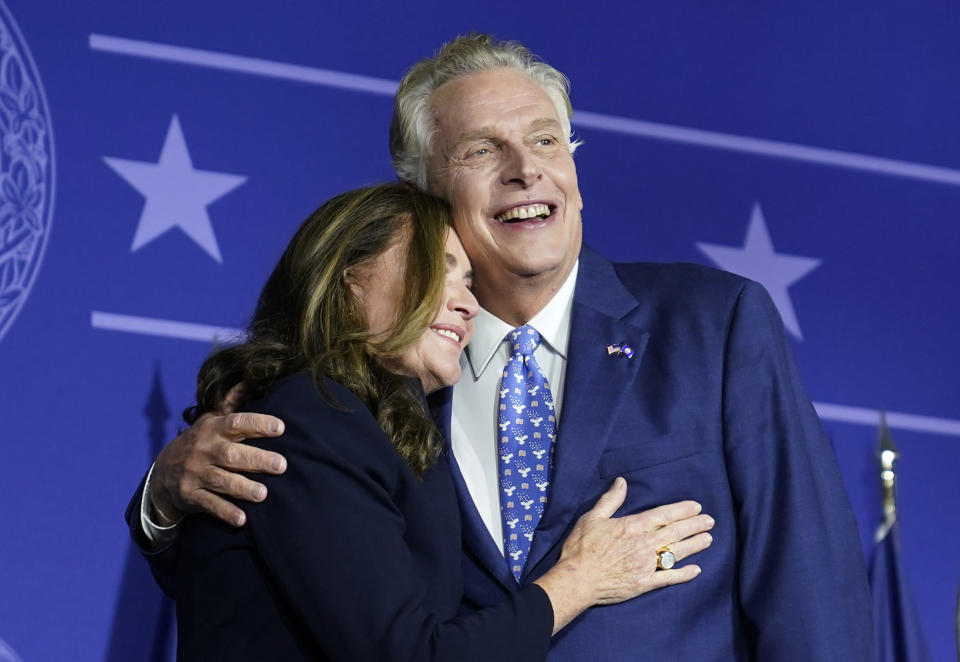 Democratic gubernatorial candidate Terry McAuliffe, right, hugs his wife, Dorothy, as he makes an appearance at an election night party in McLean, Va., Tuesday, Nov. 2, 2021.  (Steve Helber/AP)