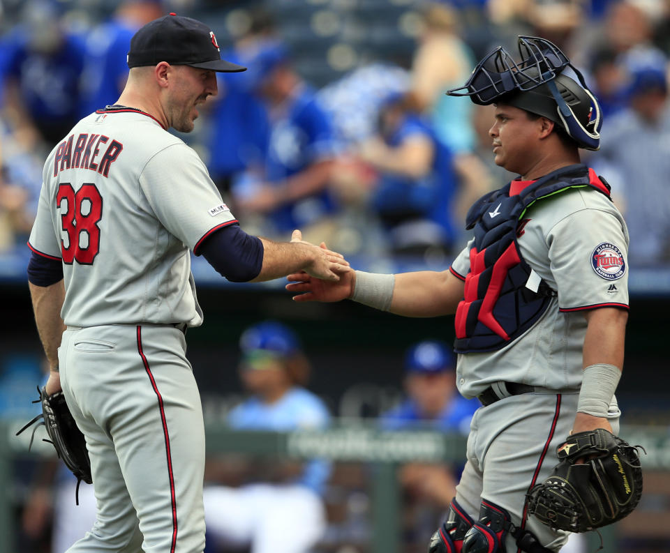 Minnesota Twins relief pitcher Blake Parker (38) and catcher Willians Astudillo, right, celebrate following a baseball game against the Kansas City Royals at Kauffman Stadium in Kansas City, Mo., Saturday, June 22, 2019. (AP Photo/Orlin Wagner)