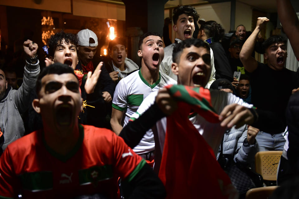 Morocco fans celebrate as they watch their team win the match against Spain at the World Cup soccer match tournament in Qatar, in Tudela, northern Spain, Tuesday, Dec. 6, 2022. (AP Photo/Alvaro Barrientos)