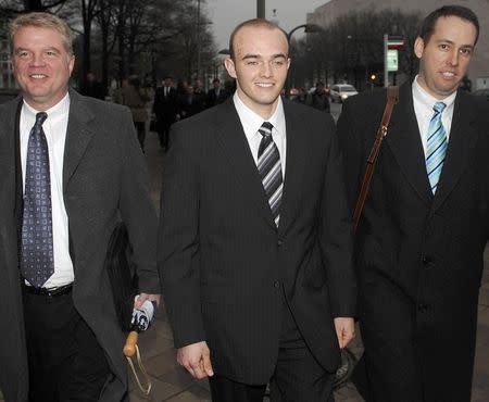 Blackwater Worldwide security guard Nick Slatten (C) and attorneys leave the federal courthouse after being arraigned with 4 fellow Blackwater guards on manslaughter charges for allegedly killing 14 unarmed civilians and wounding 20 others in a 2007 shooting in Baghdad, in Washington in this January 6, 2009 file photo. REUTERS/Jonathan Ernst