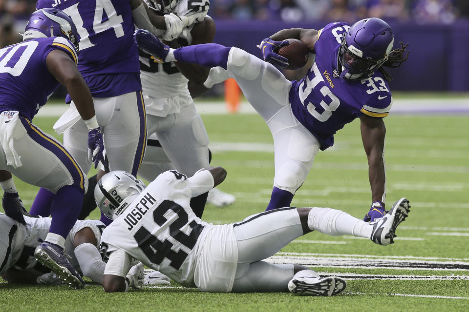 Minnesota Vikings running back Dalvin Cook (33) is upended by Oakland Raiders free safety Karl Joseph (42) during the first half of an NFL football game, Sunday, Sept. 22, 2019, in Minneapolis. (AP Photo/Jim Mone)