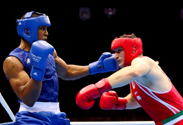 LONDON, ENGLAND - AUGUST 12: Anthony Joshua (L) of Great Britain exchanges punches with Roberto Cammarelle (R) of Italy during the Men's Super Heavy ( 91kg) Boxing final bout on Day 16 of the London 2012 Olympic Games at ExCeL on August 12, 2012 in London, England. (Photo by Scott Heavey/Getty Images)