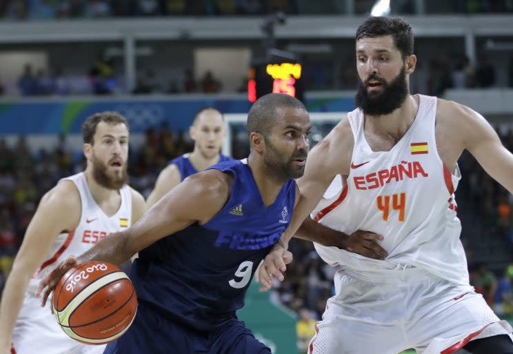 France's Tony Parker (9) drives the ball around Spain's Nikola Mirotic (44) during a men's quarterfinal round basketball game at the 2016 Summer Olympics in Rio de Janeiro, Brazil, Wednesday, Aug. 17, 2016. (AP Photo/Eric Gay)