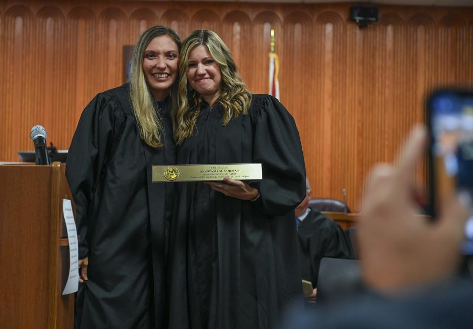 Newly appointed Circuit Judge Anastasia Norman (center) poses with Circuit Judge Rebecca White after receiving her plaque from Judge White during Judge Norman's investiture ceremony on Friday, Oct. 13, 2023, at the St. Lucie County Courthouse in Fort Pierce.