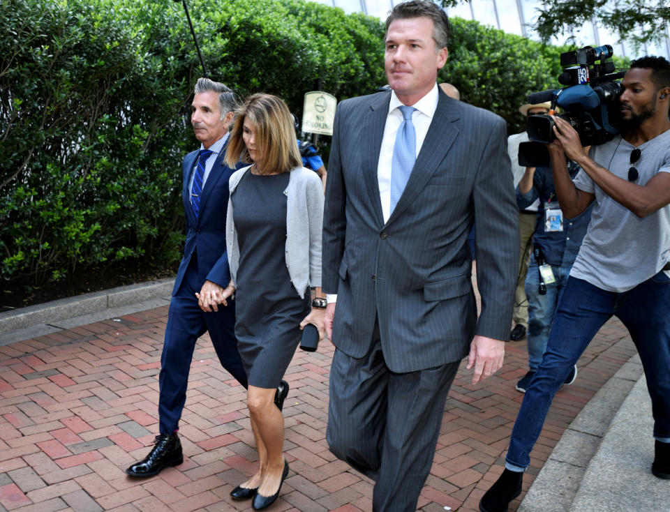Actress Lori Loughlin and her husband, fashion designer Mossimo Giannulli, arrive at the federal courthouse for a hearing on charges in a nationwide college admissions cheating scheme in Boston, Massachusetts, U.S., August 27, 2019.  REUTERS/Josh Reynolds