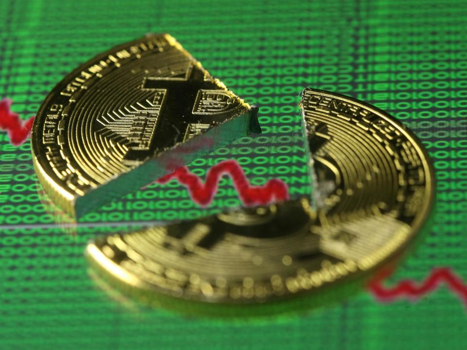 Broken representation of the Bitcoin virtual currency, placed on a monitor that displays stock graph and binary codes, are seen in this illustration picture, December 21, 2017: Reuters