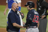 Atlanta Braves' Adam Duvall is checked by a trainer during the second inning in Game 1 of a baseball National League Championship Series against the Los Angeles Dodgers Monday, Oct. 12, 2020, in Arlington, Texas. Duvall left the game. (AP Photo/Tony Gutierrez)