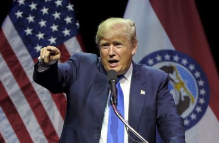 U.S. Republican presidential candidate Donald Trump points out a protester during a campaign rally at the downtown Midland Theater in Kansas City, Missouri, March 12, 2016. REUTERS/Dave Kaup