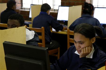 Students use computers to study at Elswood Secondary School in Cape Town November 7, 2013. REUTERS/Mike Hutchings