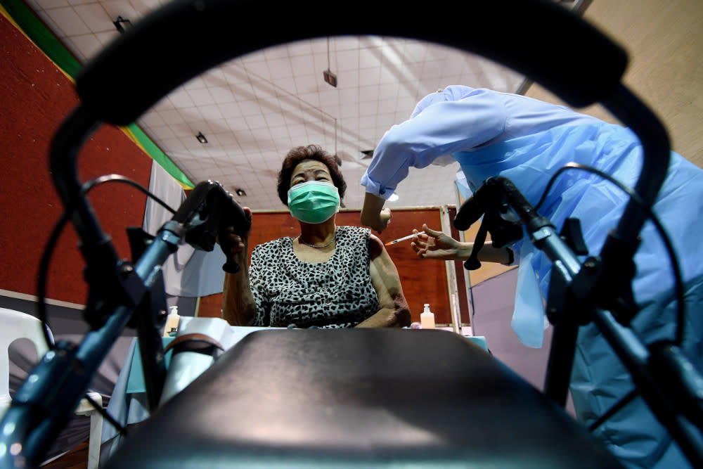 Senior citizen Yuen Mee Van, 81, receiving a Covid-19 jab during the Phase 2 Vaccination programme at the Sandakan Community Hall in Sabah, April 19, 2021. — Bernama pic