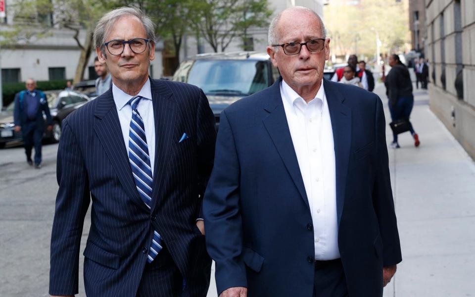 Former Rochester Drug Co-Operative CEO Laurence Doud III, right, leaves court in New York - AP