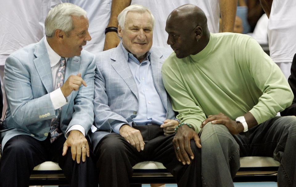 Former North Carolina coach Roy Williams, left, former coach Dean Smith and all-time great Michael Jordan, right, share a moment in September 2009 prior to an alumni game to help celebrate the school’s 100th year of basketball.