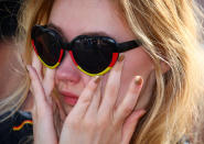 <p>A Germany fan reacts as she watches the match at a public viewing area at Brandenburg Gate. REUTERS/Hannibal Hanschke </p>