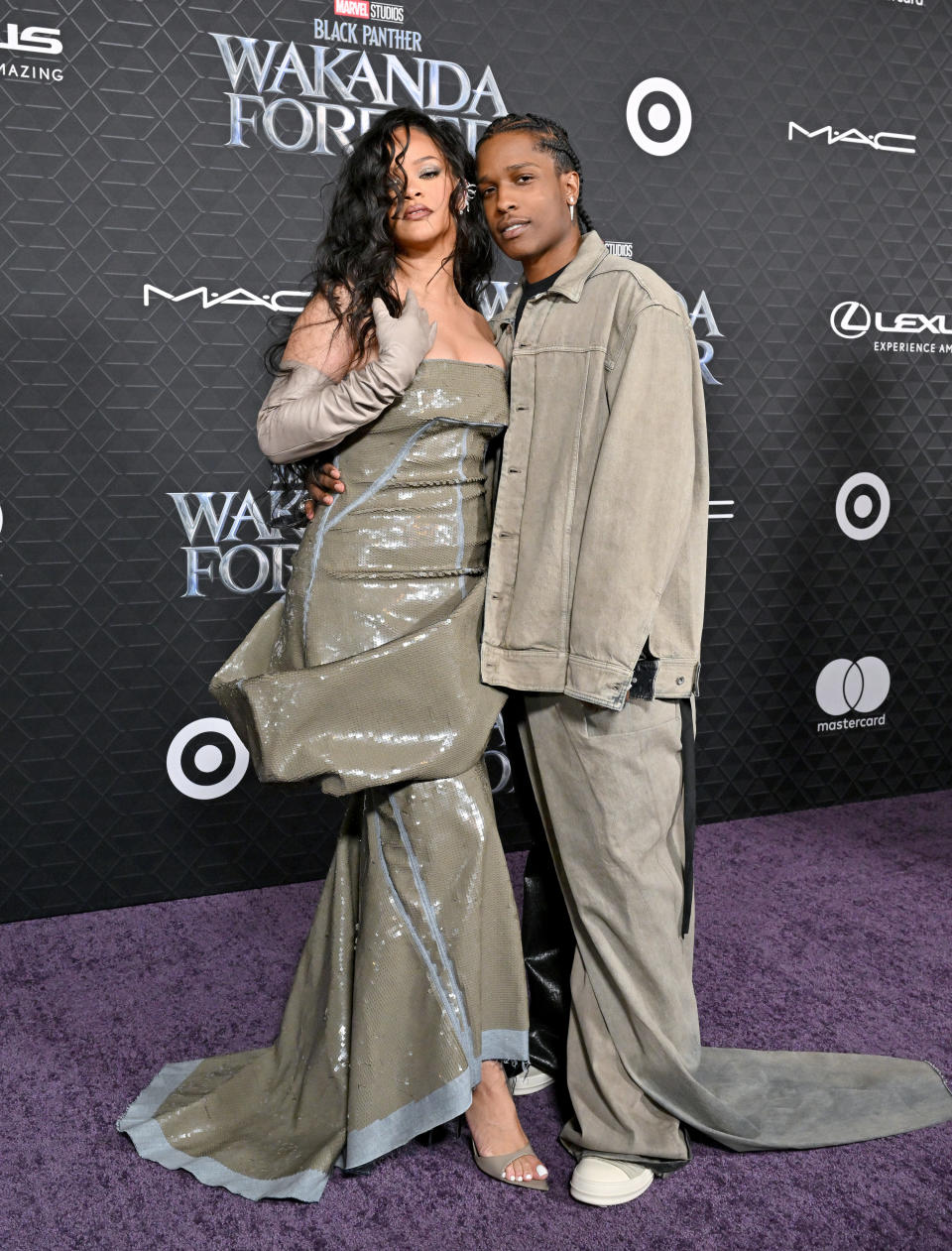 Rihanna wearing a strapless sequined gown and matching opera gloves.&nbsp;A$AP Rocky wearing oversized pants and a matching jacket and t-shirt