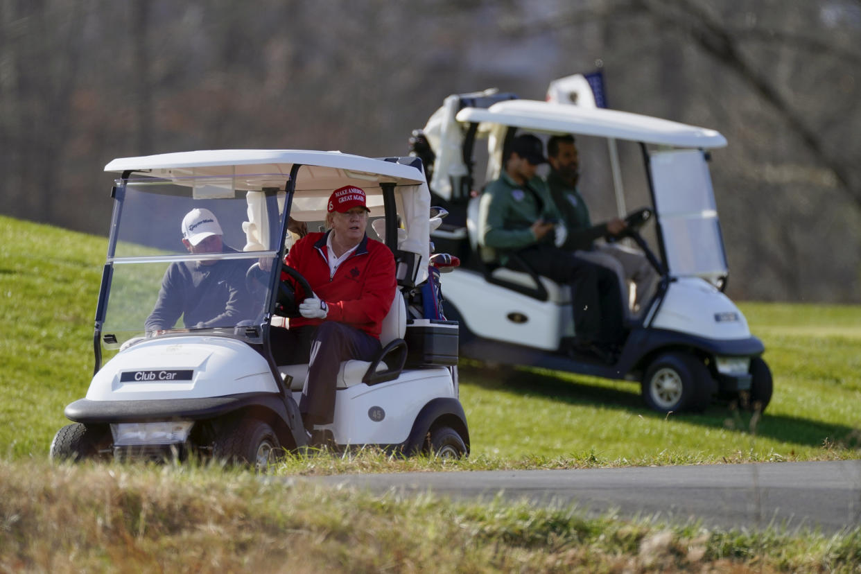 President Donald Trump drives a golf cart as he plays golf at Trump National Golf Club, Saturday, Nov. 28, 2020, in Sterling, Va. (AP Photo/Alex Brandon)