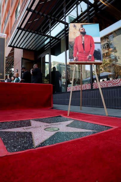 PHOTO: A portrait of late Nipsey Hussle sits next to his star during its unveiling as he is honored posthumously on the Hollywood Walk of Fame in Los Angeles, August 15, 2022.  (Mario Anzuoni/Reuters)