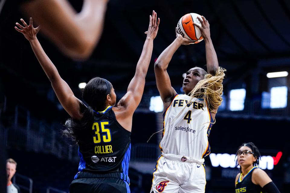 Indiana Fever center Queen Egbo (4) shoots over Dallas Wings forward Charli Collier (35) in the first half of a WNBA basketball game in Indianapolis, Sunday, July 24, 2022. (AP Photo/Michael Conroy)