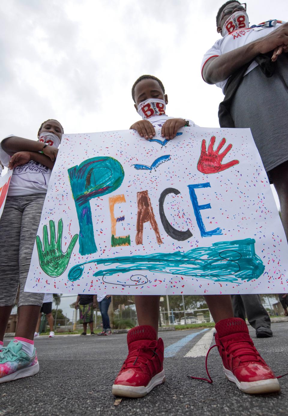 More than 100 adults and children marched together to celebrate freedom, freedom from slavery, during the 20th Annual Juneteenth Celebration of Freedom Peace and Unity Walk on Friday, June 19, 2020, in Fort Pierce. Juneteenth is a holiday celebrating the end of slavery, celebrated annually on the 19th of June. The march began at 10 a.m. going north on 13th Street, from Avenue E to Avenue O, across from Horatio Grisby Park, followed by a circle of prayer, with all the marchers side by side for eight minutes and forty six seconds in remembrance of George Floyd who died in Minnesota after a police officer kneeled on Floyd's neck for that length of time.