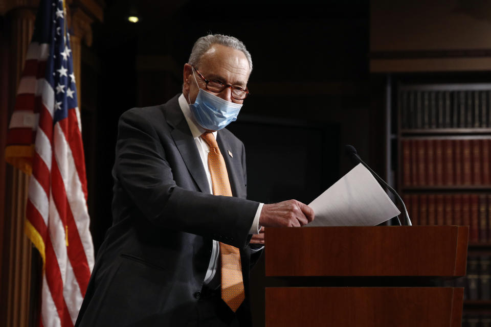 Senate Minority Leader Sen. Chuck Schumer of N.Y., center, arrives for a news conference on Capitol Hill in Washington, Tuesday, May 12, 2020. (AP Photo/Patrick Semansky)