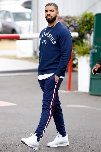 Drake in a red, white, and blue sweatsuit.