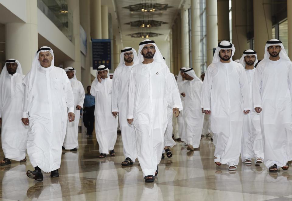 Sheik Mohammed bin Rashid Al Maktoum, center, arrives for the 'Smart Dubai' launch in Dubai, United Arab Emirates, Wednesday, March 5, 2014. After years of chasing the biggest and the best, the fast-growing Mideast city of Dubai is turning to technology to help the little things in life run more smoothly. (AP Photo/Kamran Jebreili)