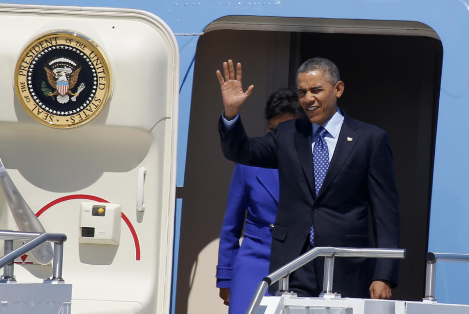 President Barack Obama, followed by Commerce Secretary Penny Pritzker, waves as they leaves Air Force One after arriving at the 171st Air Refueling Wing at the Pennsylvania Air National Guard base in Coraopolis, Pa., Wednesday, April 16, 2014. Obama joined Vice President Joe Biden in the Pittsburgh area to speak at a nearby community college about job training grants. (AP Photo/Keith Srakocic)