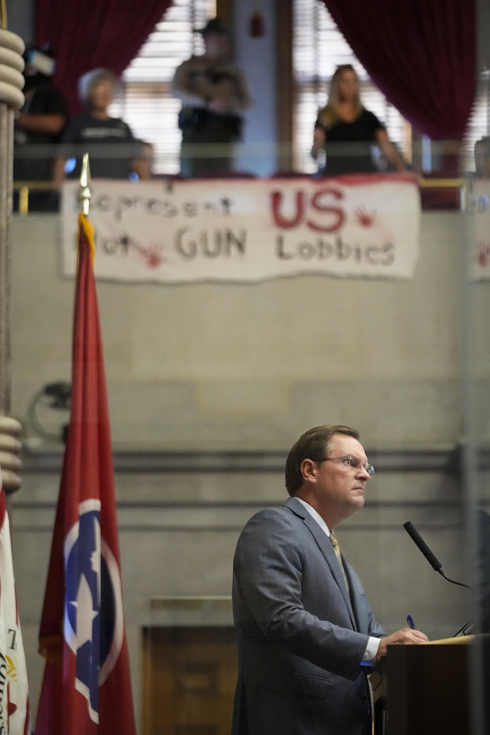 House Speaker Cameron Sexton, R-Crossville, listens as demonstrators display a banner for gun law reform over the chamber floor during a special session of the state legislature on public safety Monday, Aug. 28, 2023, in Nashville, Tenn. (AP Photo/George Walker IV)